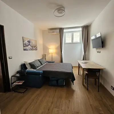 a bedroom with a bed and a table in it at The Place Milizie in Rome