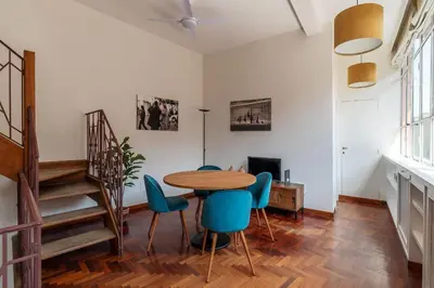 a dining room with a table and blue chairs at 2 BR Flat with Vatican Terrace in Rome