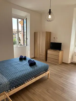 a bedroom with a bed with two slippers on it at Lotto 10 in Rome