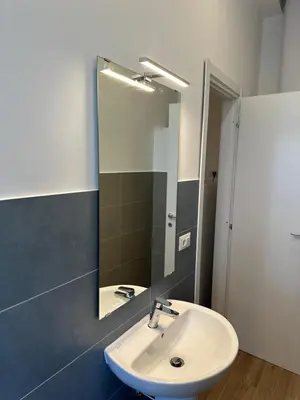 a bathroom with a sink and a mirror at Lotto 10 in Rome