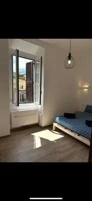 a bedroom with a bed and a window at Lotto 10 in Rome