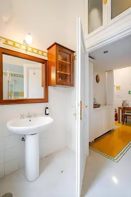 a bathroom with a sink and a mirror at S.Pietro Elvira's retro apartment in Rome