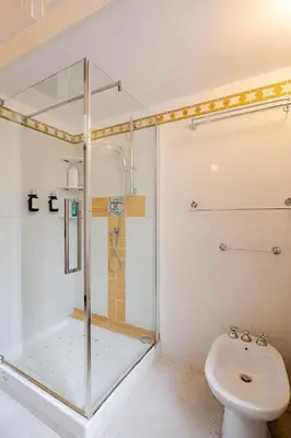 a bathroom with a shower and a toilet and a sink at S.Pietro Elvira's retro apartment in Rome