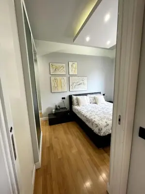 a bedroom with a bed and a wooden floor at VaticanoDreamSuite in Rome