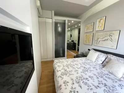 a bedroom with a bed and a flat screen tv at VaticanoDreamSuite in Rome
