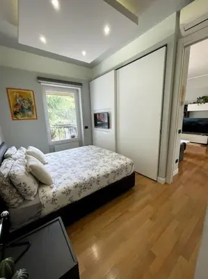 a bedroom with a bed and a large window at VaticanoDreamSuite in Rome