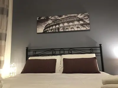 a bedroom with a bed with a picture on the wall at Residenza San Martino in Rome