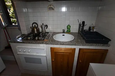 a kitchen counter with a sink and a stove at Residenza San Martino in Rome