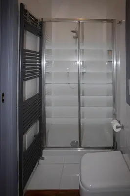 a bathroom with a glass shower with a toilet at Residenza San Martino in Rome