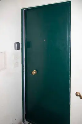 a green door with a gold handle in a room at Residenza San Martino in Rome