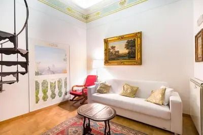 a living room with a white couch and a painting on the wall at Trevispagna Charme Apartment Autonomous in Rome