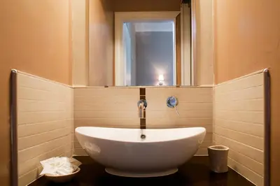a white sink in a bathroom with a mirror at Residenza Cernaia in Rome