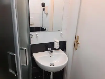 a small bathroom with a sink and a mirror at Residenza Cernaia in Rome