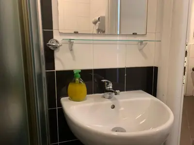 a bathroom sink with a bottle of soap on it at Residenza Cernaia in Rome