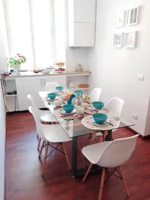 a dining room with a table and white chairs at Domus Crescenzio - Guest House in Rome