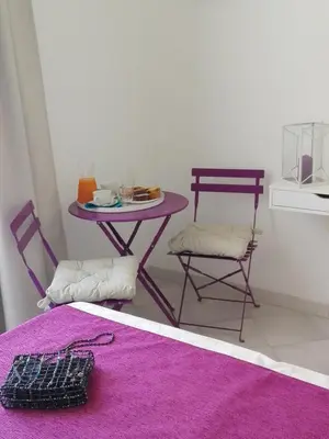 a table and two chairs and a table with a purple table at Domus Crescenzio - Guest House in Rome