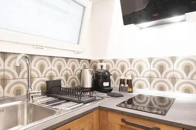 a kitchen with a sink and a stove at Trastevere Lovely 2 BR Apartment in Rome