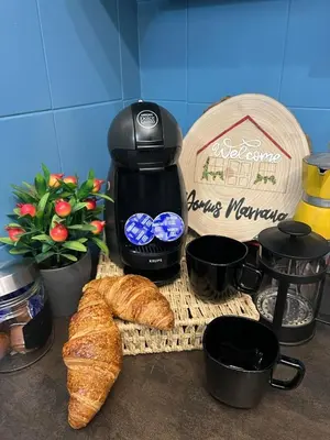 a counter with a coffee maker and bread and a coffee pot at Domus Marrana - 15 minutes far away from Coloseum in Rome