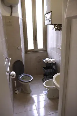 a small bathroom with a toilet and a sink at Domus Marrana - 15 minutes far away from Coloseum in Rome