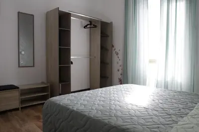 a bedroom with a bed and a dresser and a window at Domus Marrana - 15 minutes far away from Coloseum in Rome