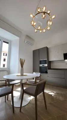 a kitchen with a table and chairs and a chandelier at Stans Dolce Lusso Basilica San Giovanni in Rome