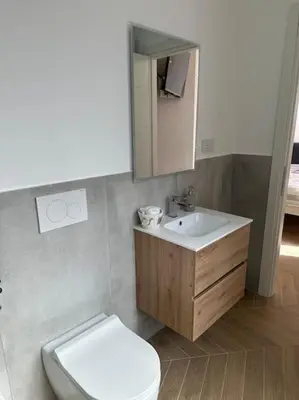 a bathroom with a white toilet and a sink at Stans Dolce Lusso Basilica San Giovanni in Rome