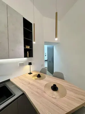 a kitchen with a wooden counter with two hats on it at Stans Dolce Lusso Basilica San Giovanni in Rome