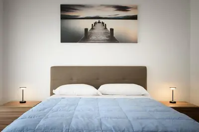 a bedroom with a bed with a picture of a pier at vatican house in Rome