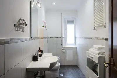 a white bathroom with a sink and a toilet at vatican house in Rome