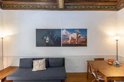 a living room with a blue couch and a wooden table at Frattina Atmosphere by Rental in Rome in Rome