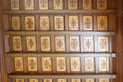 a wooden wall with gold designs on it at Frattina Atmosphere by Rental in Rome in Rome