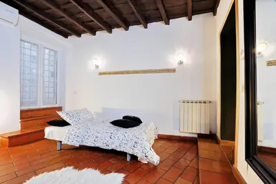 a room with a bed with pillows on it at 3Chic Maison Colosseo in Rome