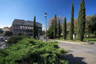 a park with trees and a building and a street light at 3Chic Maison Colosseo in Rome