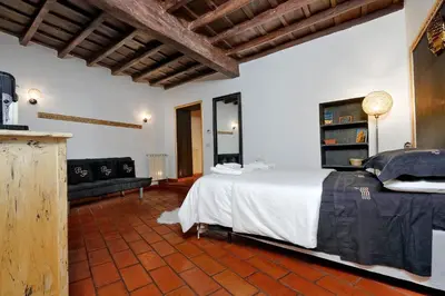 a bedroom with a bed and a couch in a room at 3Chic Maison Colosseo in Rome