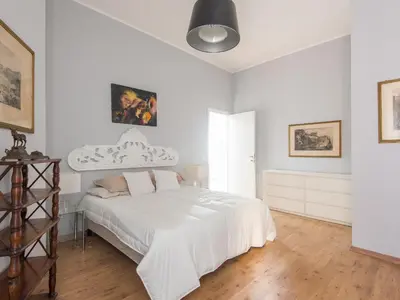 a white bedroom with a large white bed in it at Auditorium Luxury Apartments in Rome