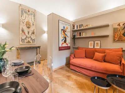 a living room with a couch and a table at The Best Rent – Charming flat near Colosseo in Rome