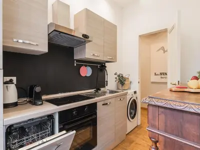 a kitchen with a stove and a dishwasher at The Best Rent – Charming flat near Colosseo in Rome