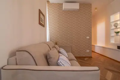 a living room with a couch in a room at Suite dei Re di Roma in Rome