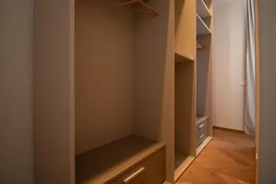 a walk in closet with a wooden floor and shelves at Suite dei Re di Roma in Rome