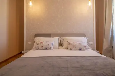 a bedroom with a large bed with two pillows at Suite dei Re di Roma in Rome