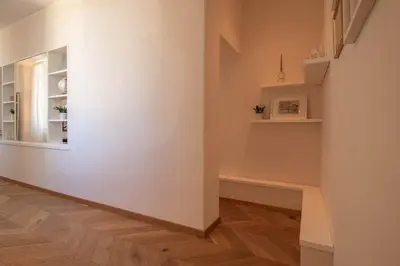 a hallway with white walls and a wooden floor at Suite dei Re di Roma in Rome
