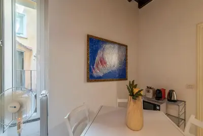 a dining room with a table with a vase on it at GuestHost - Fori Imperiali Pretty Apartment in Rome