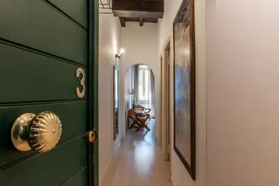 a hallway with a green door in a house at GuestHost - Fori Imperiali Pretty Apartment in Rome