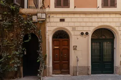 two doors on the side of a building at GuestHost - Fori Imperiali Pretty Apartment in Rome