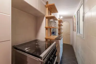 a kitchen with a stove top oven in a room at GuestHost - Fori Imperiali Pretty Apartment in Rome
