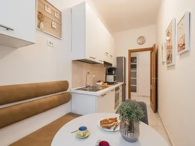 a small kitchen with a table in a room at The Best Rent – Bright two-bedrooms apartment in Testaccio area in Rome