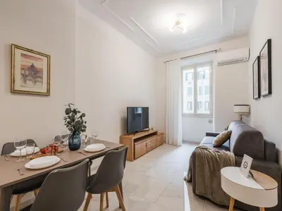 a living room with a table and a couch at The Best Rent – Bright two-bedrooms apartment in Testaccio area in Rome