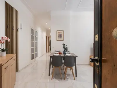 a kitchen and dining room with a table and chairs at The Best Rent – Bright two-bedrooms apartment in Testaccio area in Rome