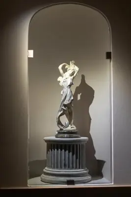 a statue of a woman in a glass case at RosaM Suite - Via Veneto 15 min walk from Spanish Steps Top Floor Luxury Apartment in Rome
