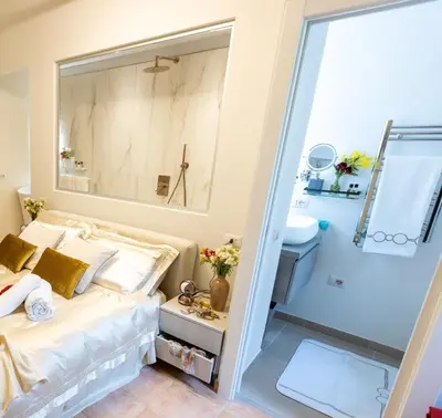 a bedroom with a bed and a shower at RosaM Suite - Via Veneto 15 min walk from Spanish Steps Top Floor Luxury Apartment in Rome